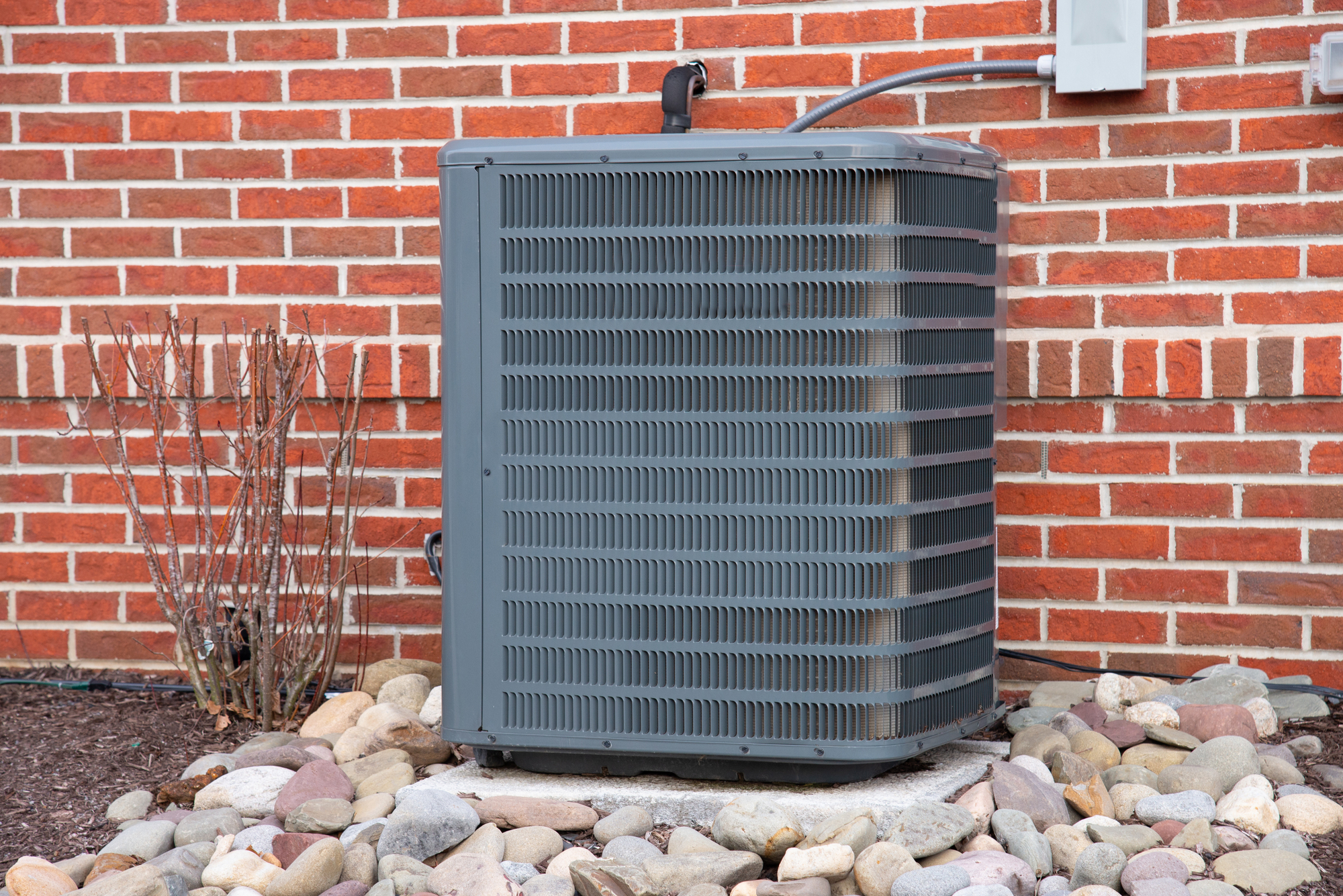 Close up shot of High efficiency modern conditioner on brick wall background cool cooling comfort