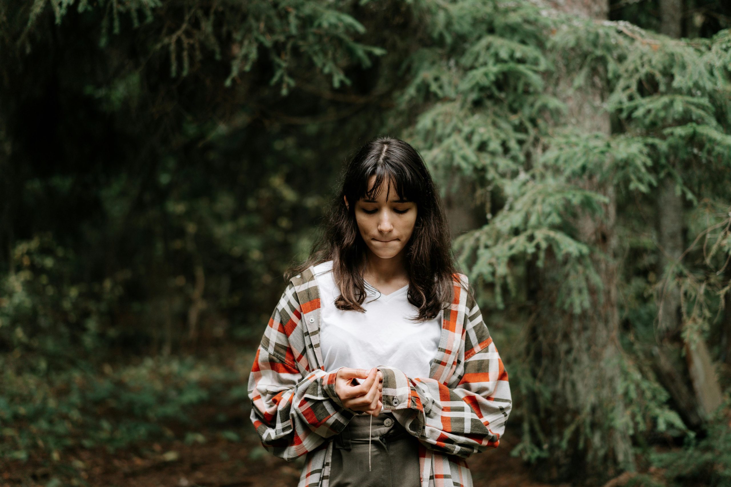 Teen girl in a park looking at her phone.